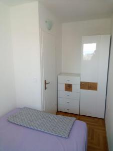 Postel nebo postele na pokoji v ubytování Apartments Tomisa