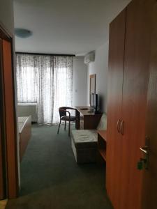 a room with a desk and a table with a couch at Kavana Stari krov in Donji Kraljevec