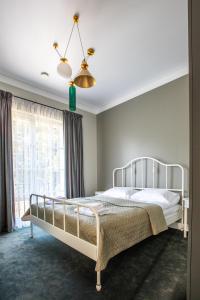 a bedroom with a bed and a lamp at Vilnius legends house I Best for families in Vilnius
