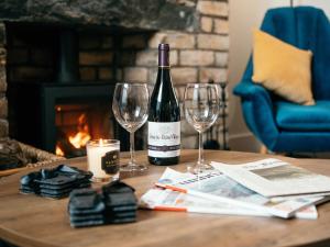 a bottle of wine and two wine glasses on a table at The Deekabout in Keswick