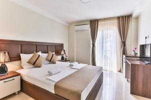 a bedroom with a large bed and a window at Atlantic sobe in Dobra Voda