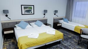 Łóżko lub łóżka w pokoju w obiekcie Hotel Rezydencja AS & Spa-Najwyżej w Karpaczu
