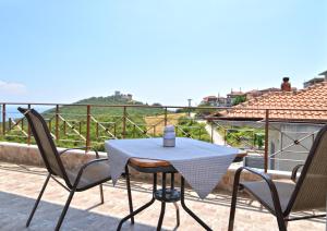 a table and two chairs on a balcony with a view at neos panteleimonas pierias VILLA LAYLA in Neos Panteleimonas