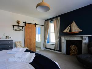 a bedroom with two beds and a fireplace at The Smugglers Rest in Woolacombe