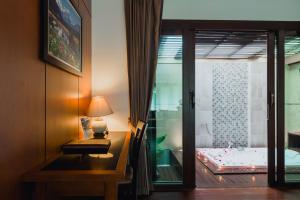 a room with a desk and a bed and a window at Railay Village Resort in Railay Beach