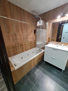 a bathroom with a sink and a mirror at Hotel TossaMar in Tossa de Mar