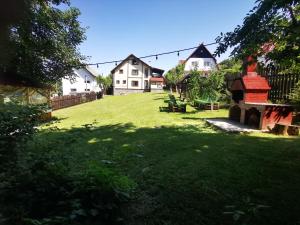 a yard with a group of houses and a green field at Casa Veveritelor in Bran
