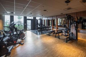 a gym with a lot of treadmills and machines at Scandic CPH Strandpark in Copenhagen