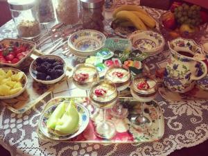 a table topped with plates and bowls of fruit at Old Drynie House, in Inverness