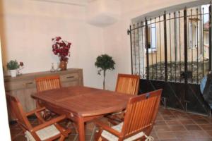 a dining room with a wooden table and chairs at Ooh La La! Oh so Provence! in Sablet +4 photos
