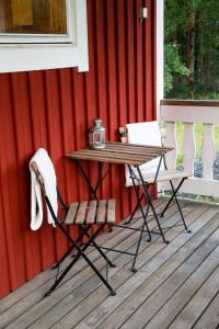 a table and two chairs on a deck at Maja Camping in Bottnaryd