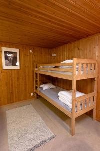 a room with two bunk beds in a wooden cabin at Maja Camping in Bottnaryd
