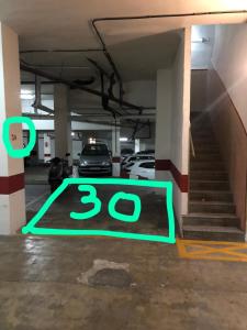 グラナダにあるAPARTAMENTO CRiSTO DE LA YEDRA CON PARKINGの- 床に制限速度の標識がある駐車場