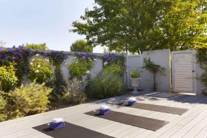 a garden with two yoga mats on a wooden deck at Silverado Resort in Napa