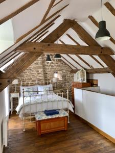 a bedroom with a bed and a brick wall at Maison de Bois Royale in Royère-de-Vassivière