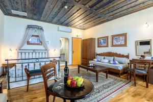 a living room with a couch and a table at Belmondo Hotel in Chania