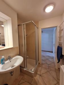 a bathroom with a shower and a sink at Dünenzauber in Ostseebad Karlshagen +10 photos