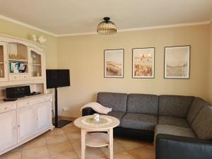 a living room with a couch and a table at Dünenzauber in Karlshagen