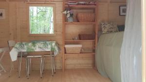 a room with a table and chairs in a cabin at Charming Cottage in Chauminet in Sougères-en-Puisaye