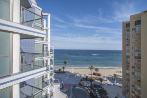 a view of the beach from the balcony of a building at Apartamentos Hipocampos Calpe Rent Apart in Calpe