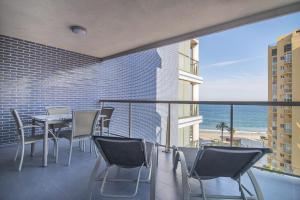 a balcony with chairs and a table and the ocean at Apartamentos Hipocampos Calpe Rent Apart in Calpe