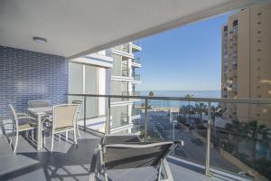 a balcony with chairs and a view of the ocean at Apartamentos Hipocampos Calpe Rent Apart in Calpe