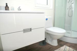 a white bathroom with a toilet and a shower at VINEA PANONIKA wine & mind retreat in Radenci +18 photos