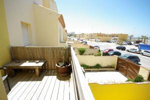 a balcony with a table and bench on a building at Livingtarifa Chalet La Caracola in Tarifa