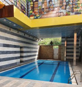 a swimming pool on top of a building at Damask Rose, Lebanese Guest House in Jounieh