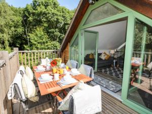 a wooden table on the deck of a house at Old Wood Coach House in Lincoln