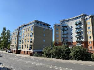 an empty street next to two tall buildings at Toothbrush Apartments - Nr Train Station in Ipswich