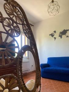 a living room with a blue couch and a chair at KB House in Pula