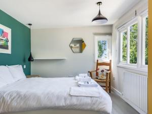 a bedroom with a bed and a tv on the wall at Pass the Keys The Beach Treehouse A Splendid Tranquil Retreat in Herne Bay