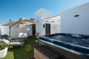 a hot tub on the balcony of a house at Magno Apartments Alameda 1851 Penthouse - Private terrace and jacuzzi in Seville