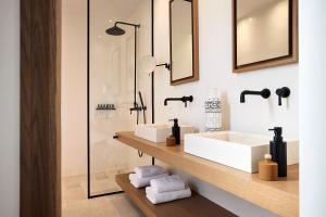 a bathroom with a sink and a mirror at Costa Mare Milos - Delmar Collection in Pollonia