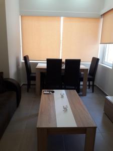 a dining room with a table and chairs at Plakoures Home in Kounoupidhianá
