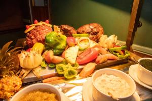 a tray of food with vegetables and dip on a table at BON Hotel Bloemfontein Central in Bloemfontein +46 photos