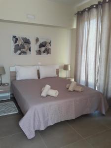 a bedroom with a large bed with two pillows on it at Plakoures Home in Kounoupidhianá