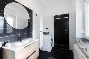 a bathroom with a sink and a washing machine at Apartman Justina Medulin for 2 person in Medulin +20 photos