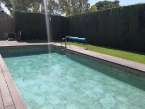 a swimming pool with a fountain in a yard at La Luna Blanca in Torremolinos