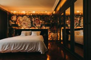 a bedroom with a bed with a floral wall at The Felix 10 in Lisbon