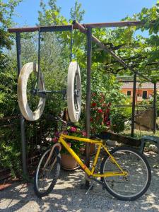 a yellow bike parked next to a swing at Agriturismo Colle Dei Venti in Arsita +15 photos