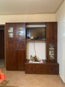 a large wooden entertainment center with a flat screen tv at Agriturismo Colle Dei Venti in Arsita