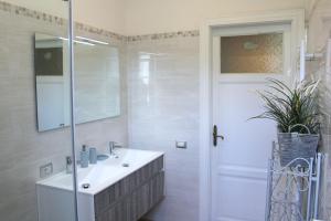 a bathroom with a sink and a shower with a mirror at Elegant Sweet Apt Cernobbio Centro in Cernobbio