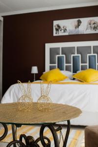 two baskets on a table in front of a bed at If Not Why Not Guesthouse in Potchefstroom