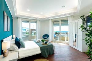 a bedroom with a bed and a balcony at Ostia Holiday Boutique SPA in Lido di Ostia