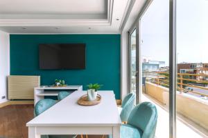a dining room with a table and chairs and a large window at Ostia Holiday Boutique SPA in Lido di Ostia