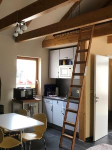 a kitchen with a loft bed and a table at FeWo Rehbach in Leipzig