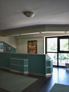 a waiting room with a reception counter in a building at Hotel Tourist - Metropol Lake Resort in Ohrid