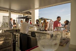 a man standing at a bar preparing a drink at Posada El Convento Mercedario by Ĥ in Ayamonte